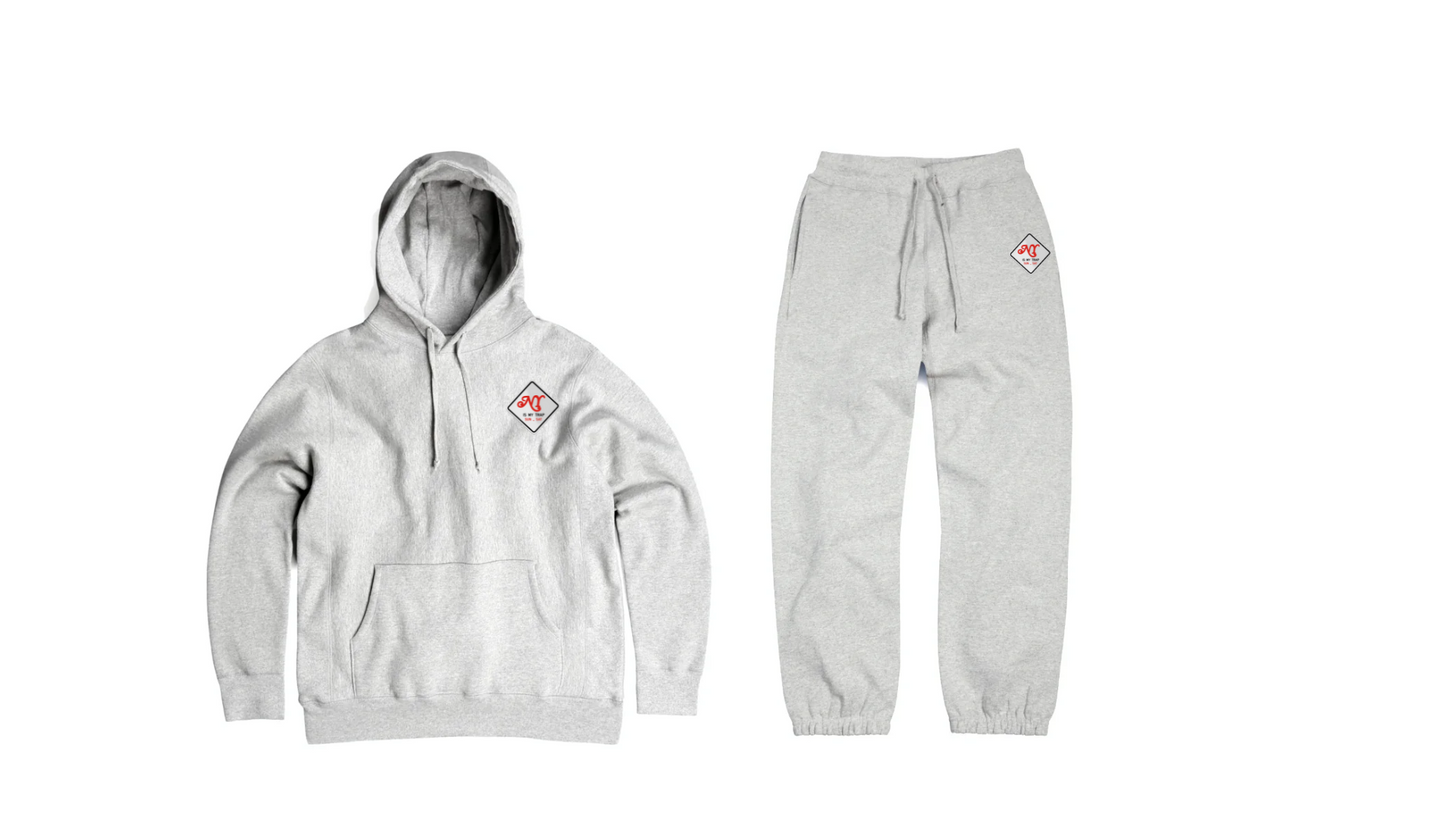 Gray hoodie and sweatpants set with a red and white logo on a white embroidered logo that say ny is my trap sun-sat 